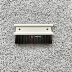 A cleaning brush with a white plastic base and black bristles, designed for a Silver Reed SK 890 Chunky Electronic Knitting Machine.