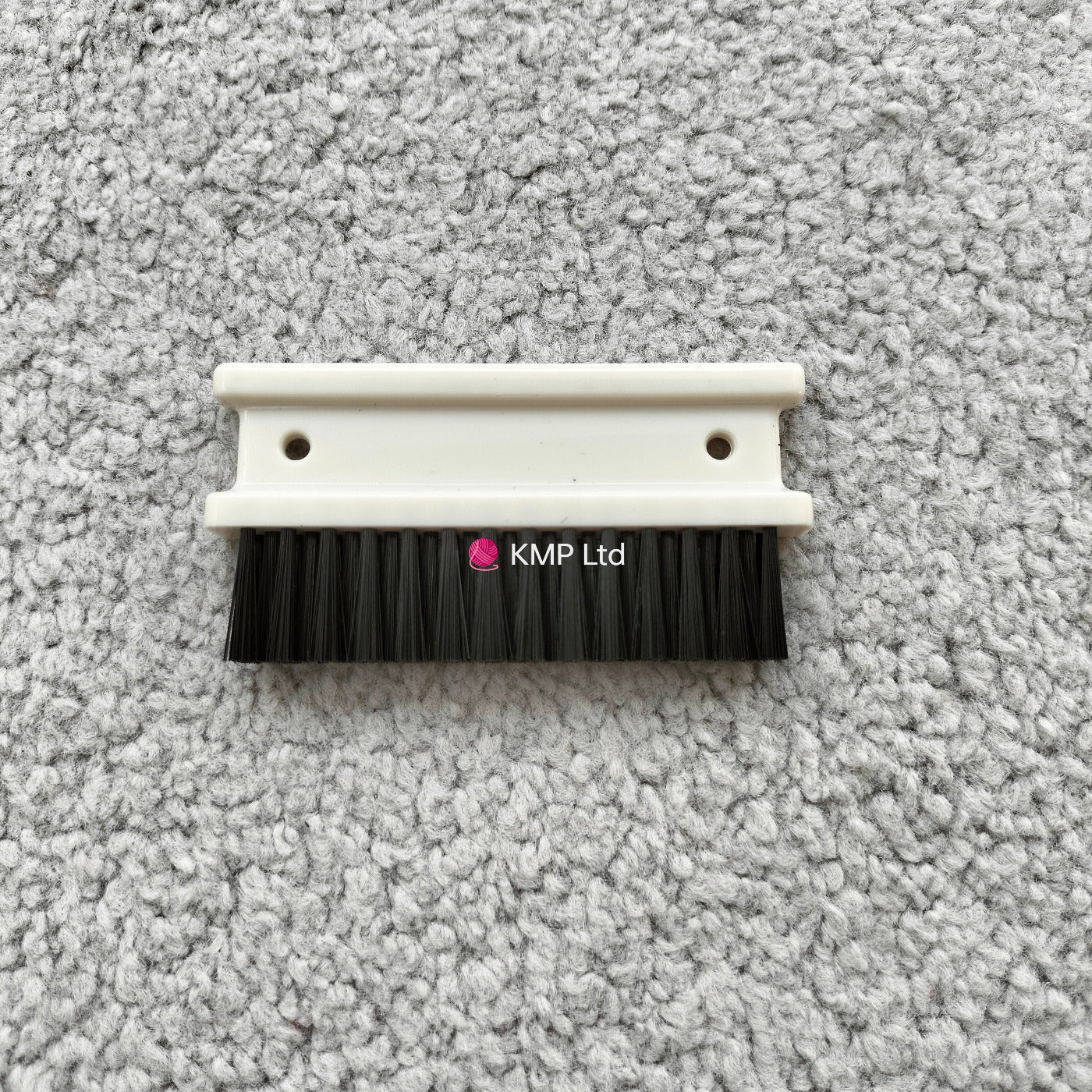 A cleaning brush with a white plastic base and black bristles, designed for a Silver Reed SK 890 Chunky Electronic Knitting Machine. Main image