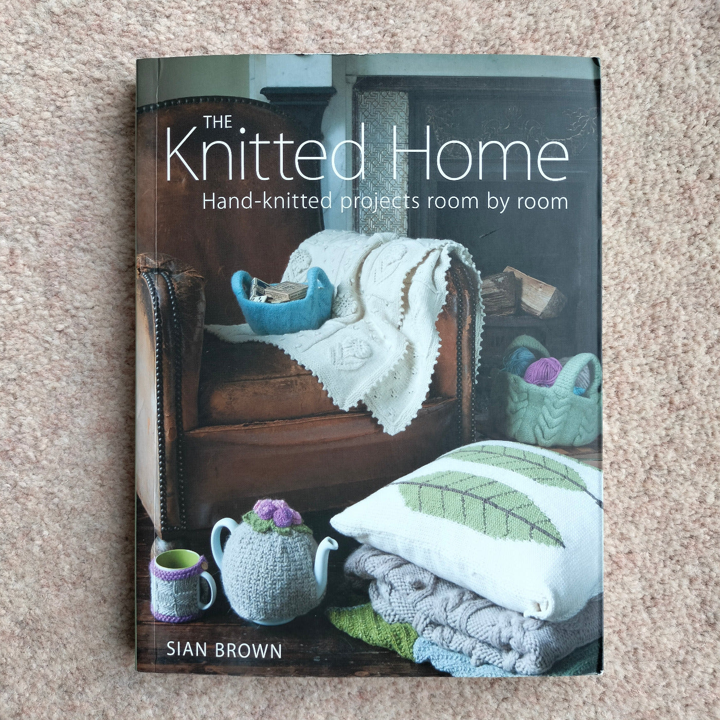 A hand knitting book called The Knitted Home: Hand-knitted projects room by room book by Sian Brown Main image