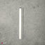 A metal cast-on comb for an electronic knitting machine Brother KH 900, lying on a grey surface.