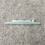 A white plastic row counter trip cam for a Passap E 6000 knitting machine, placed on a beige background.