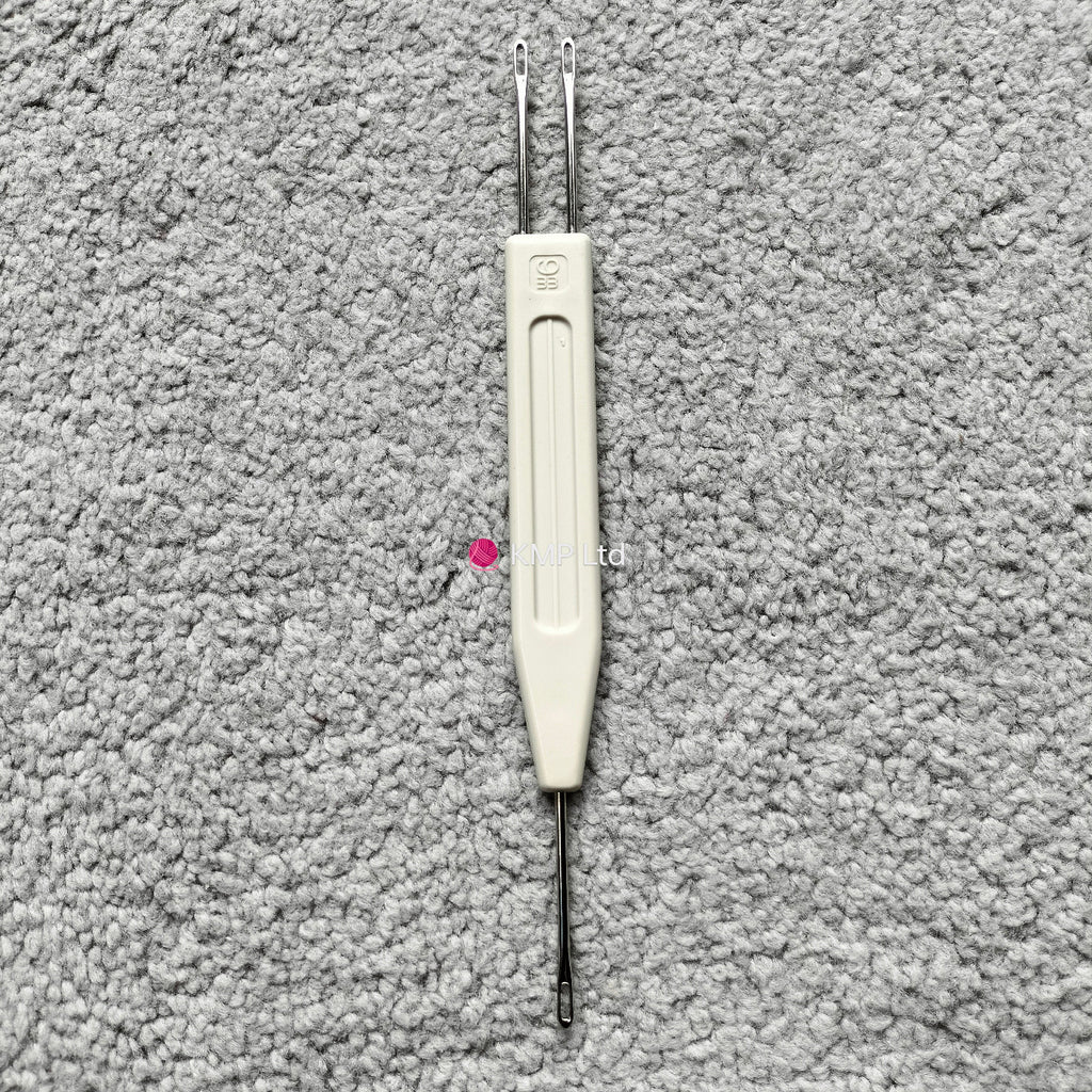 A Silver Reed chunky electronic knitting machine 1x2 stitch transfer tool, with a white handle and two metal tips