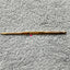 silver reed sk 890 chunky electronic-knitting machine crochet hook with '5-6' and '07' engraved on it, placed on a grey textured surface.