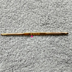 silver reed sk 890 chunky electronic-knitting machine crochet hook with '5-6' and '07' engraved on it, placed on a grey textured surface.