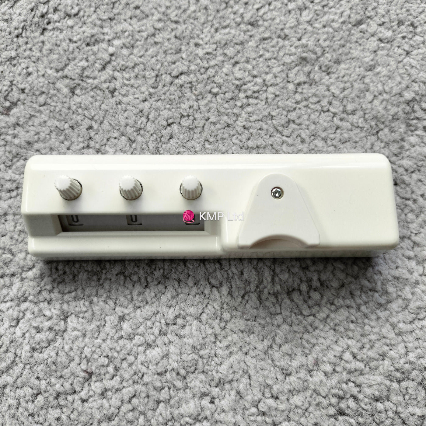 Silver Reed SK 890 Chunky Electronic Knitting Machine ROW COUNTER on a grey background, showing a white plastic body with three control buttons and a digital display.
