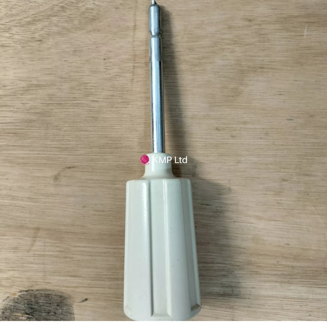 A used Toyota KR 506 Ribber Knitting Machine RACKING HANDLE with a metallic shaft and a white, rubber-coated grip, placed on a wooden surface.